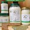 Cold pressed coconut oil beside healthy cooking ingredients and skincare products